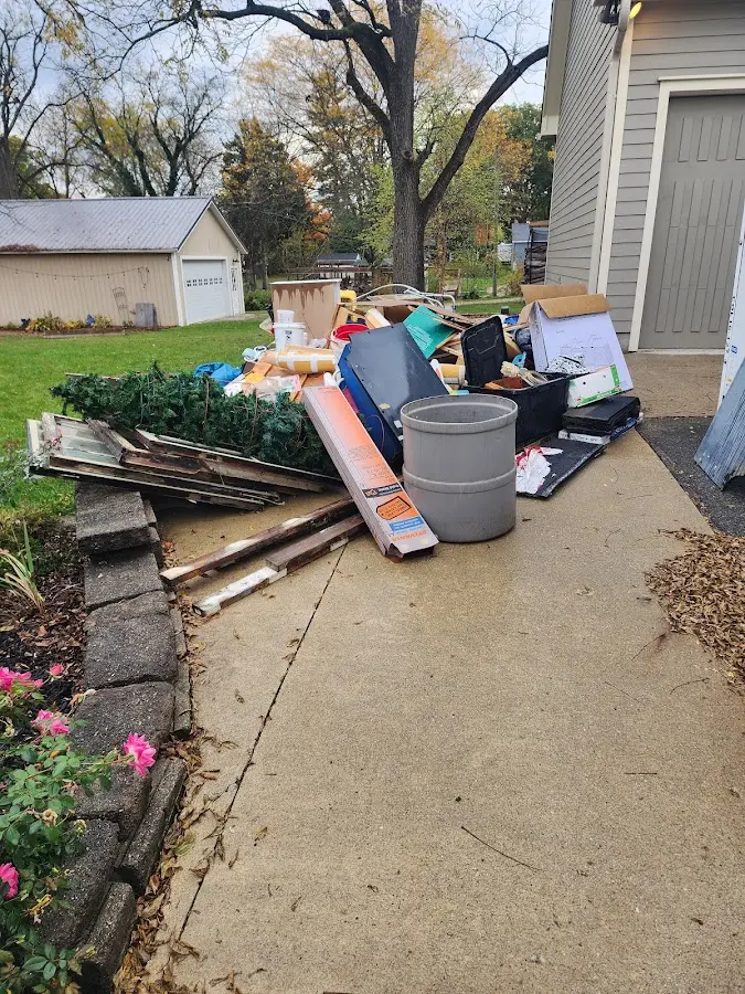 Dumpster being loaded with debris for Roofing Dumpster Rental in Castle Pines